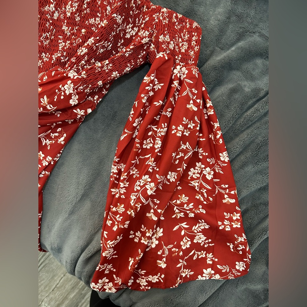 Red dress with cream flower design. Smocked top. Bell sleeve